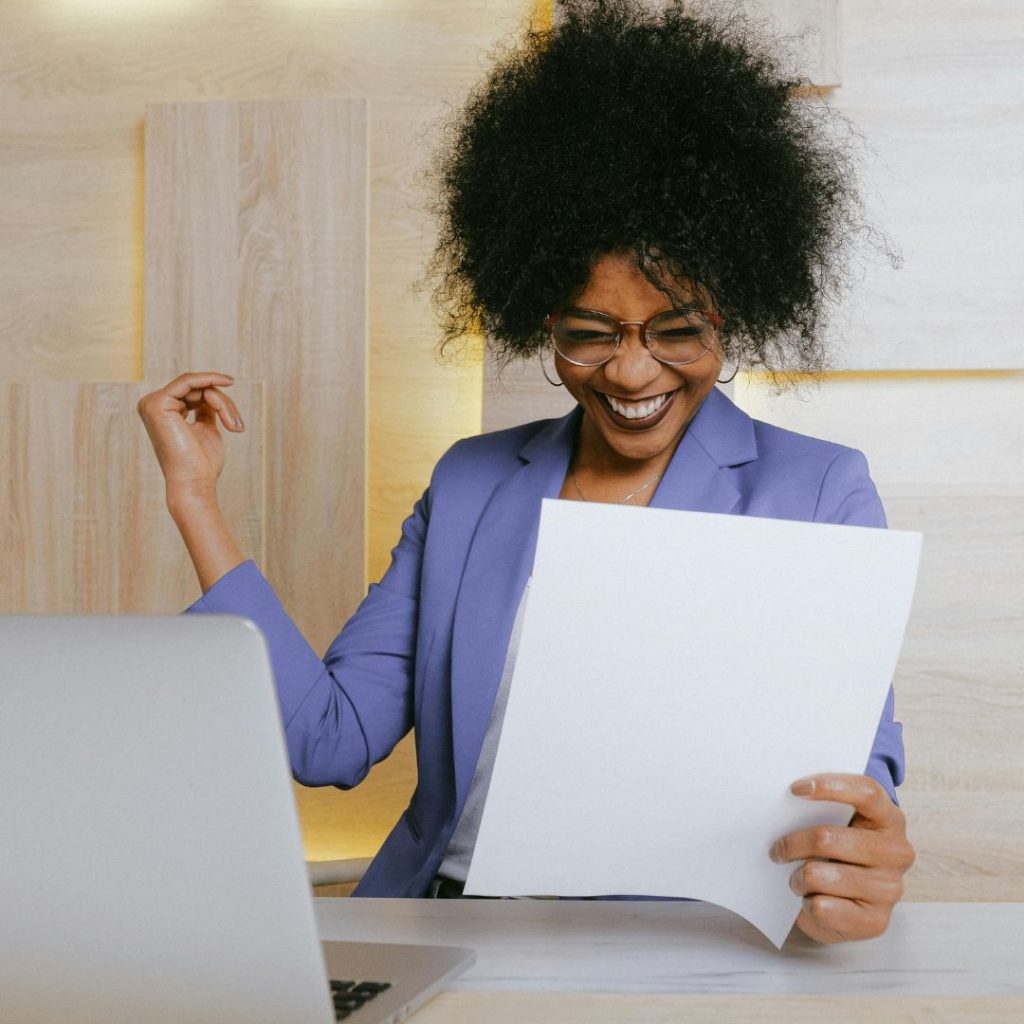 cover image for the workshop "managing stress for peak performance" shows a woman at her laptop celebrating success